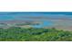 Expansive aerial shot of winding waterways weaving through marshland towards the open bay at 2468 Marina Rd, Wadmalaw Island, SC 29487