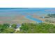 Scenic aerial view of wetlands and waterways leading to a harbor with boats and charming buildings at 2468 Marina Rd, Wadmalaw Island, SC 29487