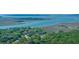 Picturesque aerial view showcasing waterfront homes and properties along a coastal waterway at 2468 Marina Rd, Wadmalaw Island, SC 29487