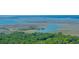 Breathtaking aerial shot showcasing a waterway flowing into a marshland ecosystem with clear skies at 2468 Marina Rd, Wadmalaw Island, SC 29487
