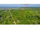 Aerial view of 2468 Marina Rd nestled in a lush green tree canopy surrounded by tidal marsh and water at 2468 Marina Rd, Wadmalaw Island, SC 29487