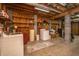 Utility basement with washer, dryer, wooden shelving and concrete walls at 2468 Marina Rd, Wadmalaw Island, SC 29487