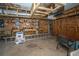 Basement workspace with wooden shelving, ladder, and concrete walls at 2468 Marina Rd, Wadmalaw Island, SC 29487