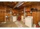 Utility basement with washer, dryer, concrete walls and wooden shelving at 2468 Marina Rd, Wadmalaw Island, SC 29487