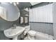 Modern bathroom with a pedestal sink, patterned tiles, and striking black walls at 2468 Marina Rd, Wadmalaw Island, SC 29487