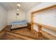 Cozy bedroom featuring wood paneled walls, wood floors, and a rustic wooden shelving unit at 2468 Marina Rd, Wadmalaw Island, SC 29487