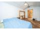 Comfortable bedroom with wooden floors, a wooden door, and a rustic shelving unit at 2468 Marina Rd, Wadmalaw Island, SC 29487
