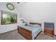 Cozy bedroom with a large window, a wood bed frame, and neutral tones at 2468 Marina Rd, Wadmalaw Island, SC 29487