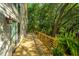 Side view of a wooden deck with sliding glass door and view of the wooded backyard at 2468 Marina Rd, Wadmalaw Island, SC 29487