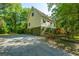 Gravel driveway leading to a charming house surrounded by a canopy of lush, mature trees at 2468 Marina Rd, Wadmalaw Island, SC 29487