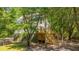 Stylish home showcasing outdoor deck, lush trees, and classic architectural design at 2468 Marina Rd, Wadmalaw Island, SC 29487
