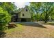 Two-story home elevated on pilings, with a screened porch and spacious backyard at 2468 Marina Rd, Wadmalaw Island, SC 29487