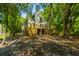 Charming two-story home with large front windows and a view of mature shade trees at 2468 Marina Rd, Wadmalaw Island, SC 29487