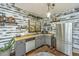 A modern kitchen featuring butcher block countertops, gray cabinets, stainless steel appliances, and shiplap walls at 2468 Marina Rd, Wadmalaw Island, SC 29487