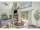 A sunlit living room offers a cozy fireplace, nautical decor, and a seamless connection to outdoor spaces at 2468 Marina Rd, Wadmalaw Island, SC 29487