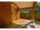 Covered porch area with wooden floors, rustic decor, and view of the backyard at 2468 Marina Rd, Wadmalaw Island, SC 29487