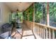 Relaxing screened porch with comfortable seating, plants, and a view of the lush greenery at 2468 Marina Rd, Wadmalaw Island, SC 29487