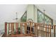 Second floor with an open floor plan, exposed beams, and large windows that let in natural light at 2468 Marina Rd, Wadmalaw Island, SC 29487