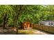 Charming shed with wooden accents, surrounded by lush greenery and a wooden fence at 2468 Marina Rd, Wadmalaw Island, SC 29487