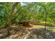 Aerial view of backyard shed surrounded by shade trees and firepit at 2468 Marina Rd, Wadmalaw Island, SC 29487