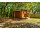 Wooden shed with porch, flower pots and shade trees at 2468 Marina Rd, Wadmalaw Island, SC 29487