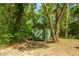 Outdoor shed with green paint and a cross buck door, surrounded by mature trees at 2468 Marina Rd, Wadmalaw Island, SC 29487