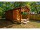 Wooden shed with porch, flowerpots, and decorative sign at 2468 Marina Rd, Wadmalaw Island, SC 29487