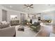 Spacious living room with hardwood floors, modern furniture, and an open flow into the kitchen at 250 Huguenot Trl, Huger, SC 29450