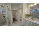 Modern bathroom with glass shower, marble tile, and vanity with a view into the closet and toilet room at 260 Huguenot Trl, Huger, SC 29450