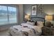Bedroom featuring a coastal theme with a printed comforter, matching lamps, and a scenic window view at 260 Huguenot Trl, Huger, SC 29450