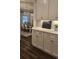 View from butler's pantry to a dining room with large windows and decorative lighting at 260 Huguenot Trl, Huger, SC 29450