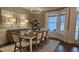 Bright dining area with large windows, chandelier, and seating for eight at 260 Huguenot Trl, Huger, SC 29450
