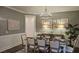 Inviting dining room with decorative wall art, a modern chandelier, and a plant at 260 Huguenot Trl, Huger, SC 29450
