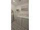 Bright laundry room features patterned tile floor, laundry machines and a decor shelf at 260 Huguenot Trl, Huger, SC 29450