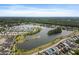 Wide aerial shot of a scenic lake community, featuring colorful homes, green spaces, and mature trees at 2747 Calico Bass Ln, Johns Island, SC 29455