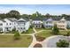 Aerial view of colorful homes in a well-maintained community with sidewalks and green spaces at 2747 Calico Bass Ln, Johns Island, SC 29455