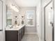 Bathroom featuring double sinks, a vanity with dark cabinets, and a glass enclosed shower at 2747 Calico Bass Ln, Johns Island, SC 29455