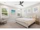 Spacious bedroom with a ceiling fan, three windows, and a comfortable bed with a padded headboard at 2747 Calico Bass Ln, Johns Island, SC 29455