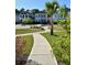 Charming homes line a walkway in this community, landscaped with green grass and a central park at 2747 Calico Bass Ln, Johns Island, SC 29455