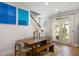 Dining room with wood table, seating, and bright artwork near the staircase with natural light from door to backyard at 2747 Calico Bass Ln, Johns Island, SC 29455