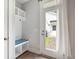Functional entryway with built-in bench, coat hooks, and storage, providing easy access to the backyard at 2747 Calico Bass Ln, Johns Island, SC 29455