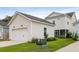 Exterior view showcasing the garage, well-maintained lawn, and landscaping of the home at 2747 Calico Bass Ln, Johns Island, SC 29455