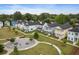 Charming street view of colorful two-story homes with inviting front porches and a communal park area at 2747 Calico Bass Ln, Johns Island, SC 29455