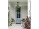 Stylish light blue front door with glass panel, decorative wreath, and potted plants adding charm to the entrance at 2747 Calico Bass Ln, Johns Island, SC 29455