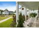 Inviting front porch with white columns and chairs, perfect for relaxing and enjoying the neighborhood views at 2747 Calico Bass Ln, Johns Island, SC 29455