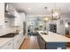Beautiful open kitchen with white cabinets, a center island, stainless steel appliances, and seamless flow to the living area at 2747 Calico Bass Ln, Johns Island, SC 29455