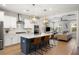 Open-concept kitchen with white cabinets, stainless steel appliances, a center island, and stylish pendant lighting at 2747 Calico Bass Ln, Johns Island, SC 29455