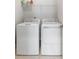 Clean laundry room with a side-by-side washer and dryer set and wire shelving for storage at 2747 Calico Bass Ln, Johns Island, SC 29455