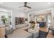 Spacious living room with an open layout, hardwood floors, a comfortable sofa, and easy access to the kitchen at 2747 Calico Bass Ln, Johns Island, SC 29455