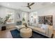 Bright and airy living room with hardwood floors, sectional sofa, and large windows providing ample natural light at 2747 Calico Bass Ln, Johns Island, SC 29455